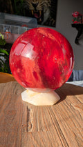 Gigantische robijnrode Smeltkwarts bol van 22 cm op een stevige houder, gewicht 12 kg. Exclusief interieur statement piece.