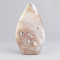 Slanke Bloemagaat punt met witte bloempatronen en roze tinten, 10,5 cm hoog en 190 gram, op een houten ondergrond.