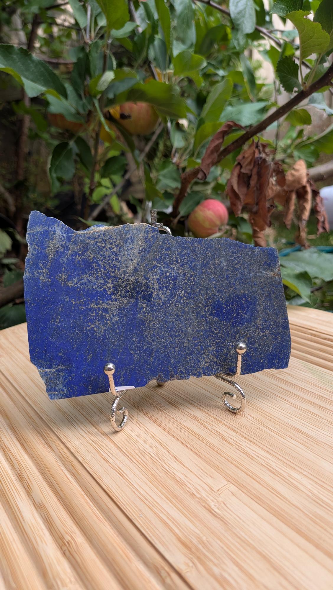 Diepblauwe gepolijste lapis lazuli plak van 211 gram met gouden pyriet op een metalen displaystandaard