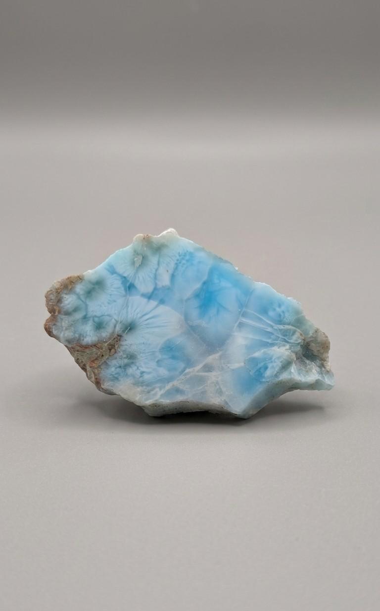 Stijlvol larimar plakje van 50 x 29 mm met karakteristieke oceaanpatronen, gefotografeerd op een neutrale achtergrond.