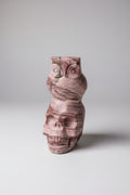 Handgemaakt roze zebra jaspis skull beeldje met een gedetailleerde uil erbovenop tegen een neutrale achtergrond