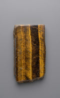Gepolijste tijgeroog slab met een strak goudbruin lijnenspel en intense zijdeglans van Edeltwist.