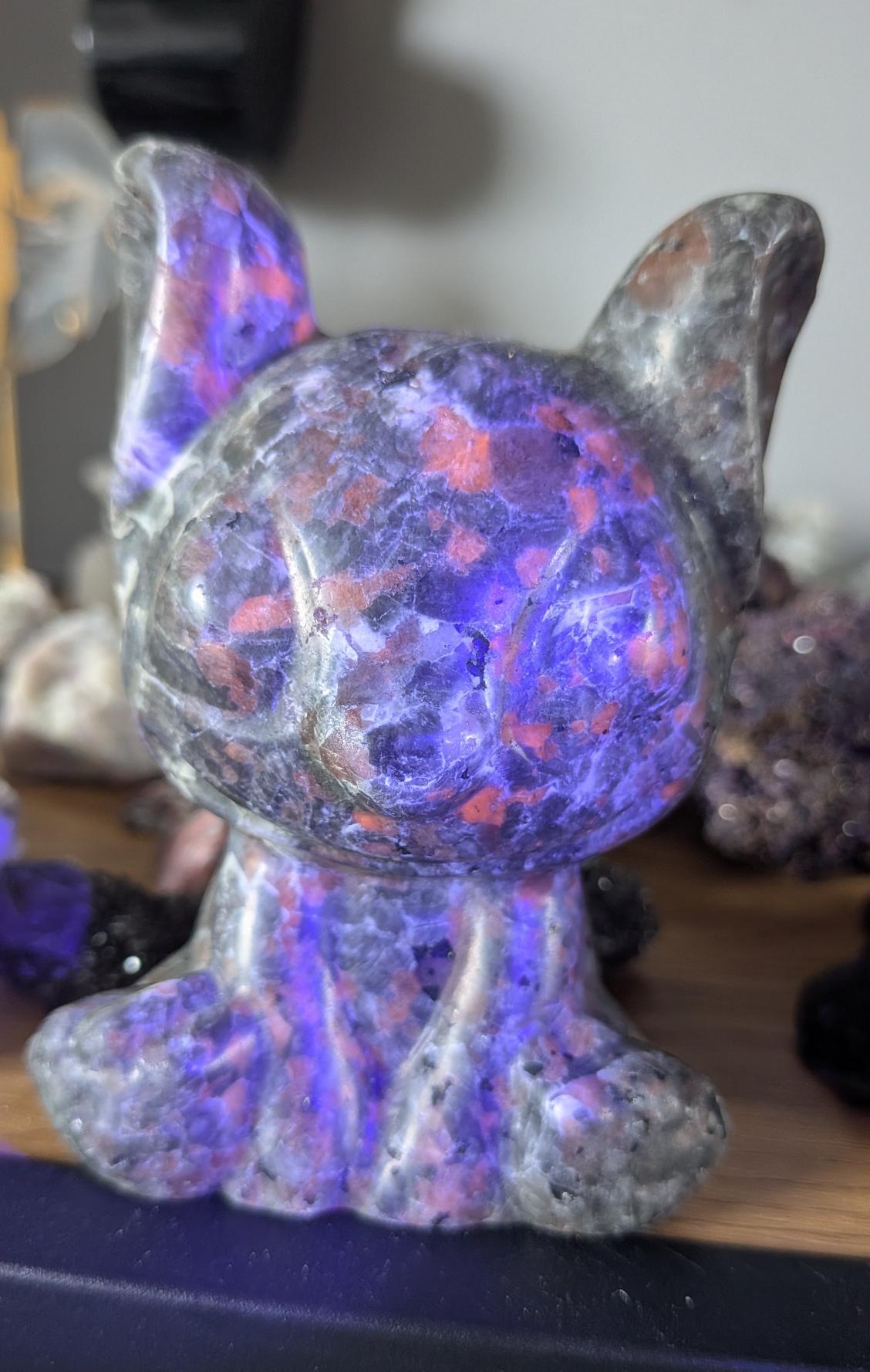 Stitch figuur van yooperlite dat fel oplicht onder UV-licht, wat een magisch effect geeft.
