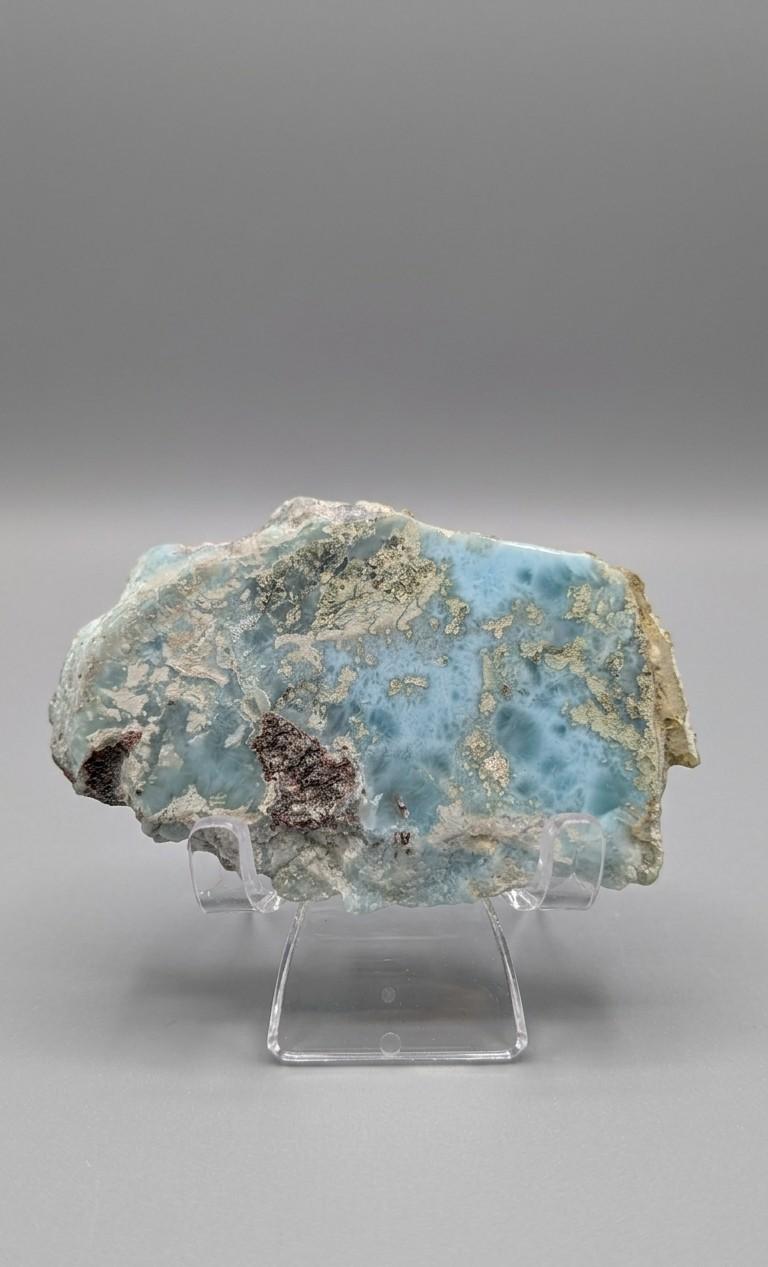 Gepolijste wit-blauwe Larimar plak met oceanisch patroon op een transparante acrylaat standaard van Edeltwist.