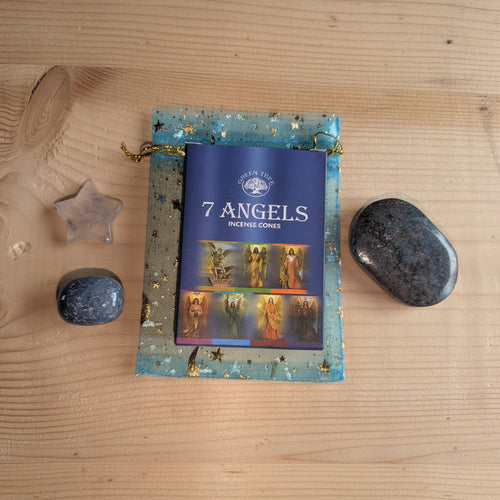 Geschenkset in een blauw organza zakje met gouden sterren, bevattende een robijn in kyaniet palmsteen, een bergkristal ster, een kwarts trommelsteen en een doosje 7 Angels wierookkegels.